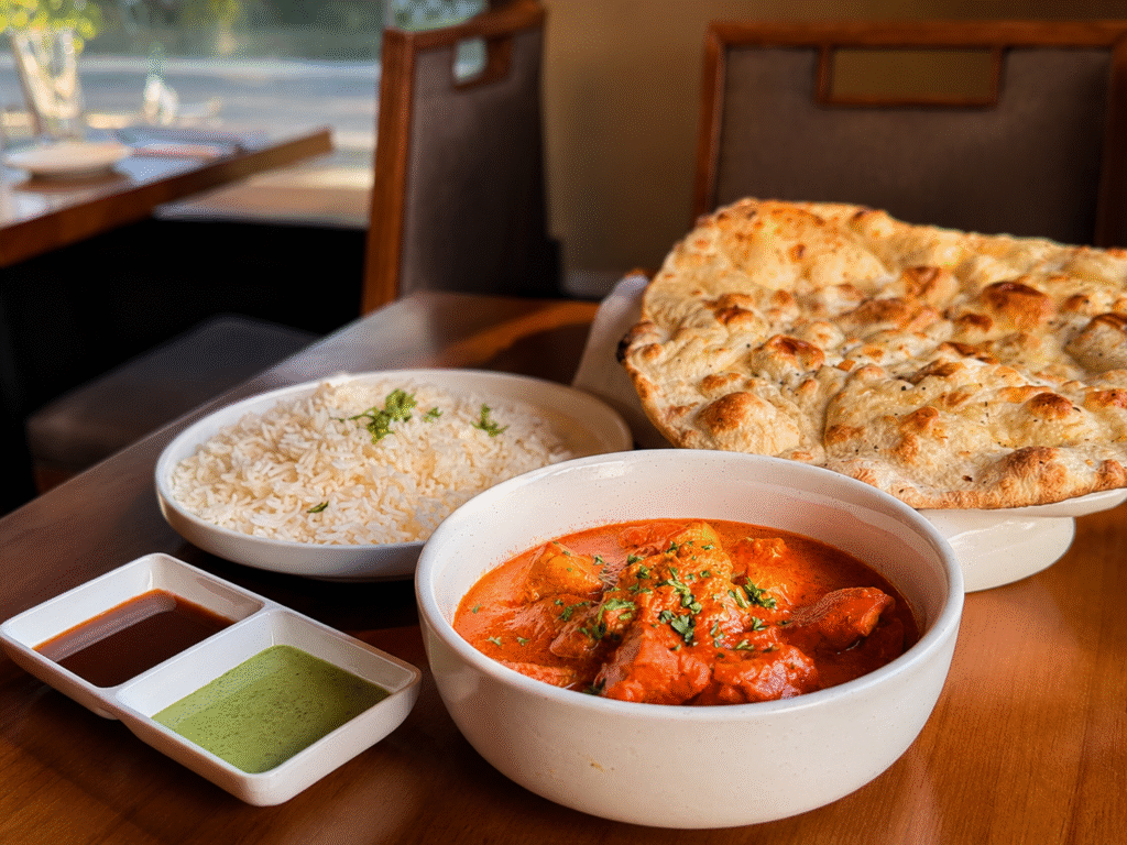 Cedars butter chicken with naan, rice, and chutneys